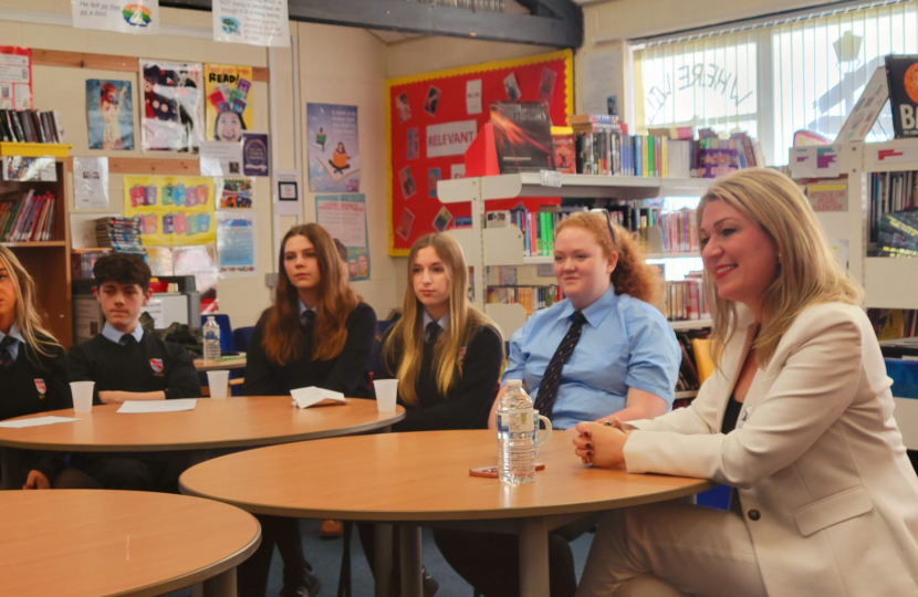 Laura at table with students