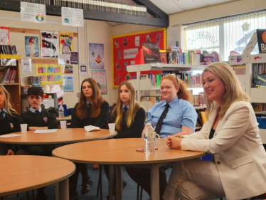 Laura at table with students